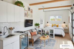 A bright and modern junior accessory dwelling unit interior, converted from a garage, with a compact kitchen and living area.