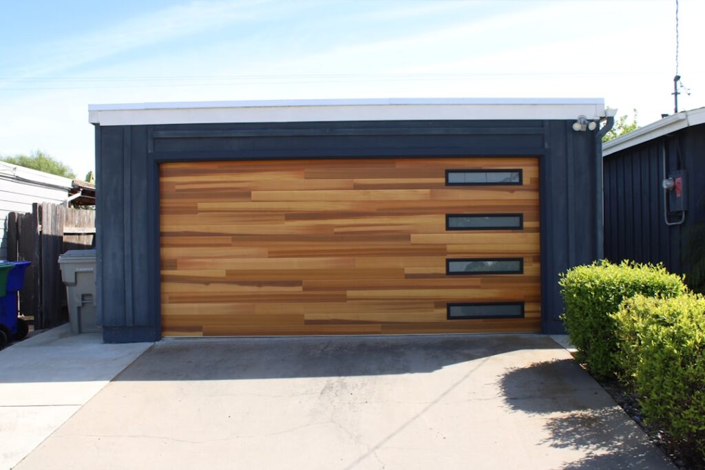 Garage door replacement with insulated wall framing, exterior siding, and a new double-pane window