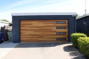 Garage door replacement with insulated wall framing, exterior siding, and a new double-pane window